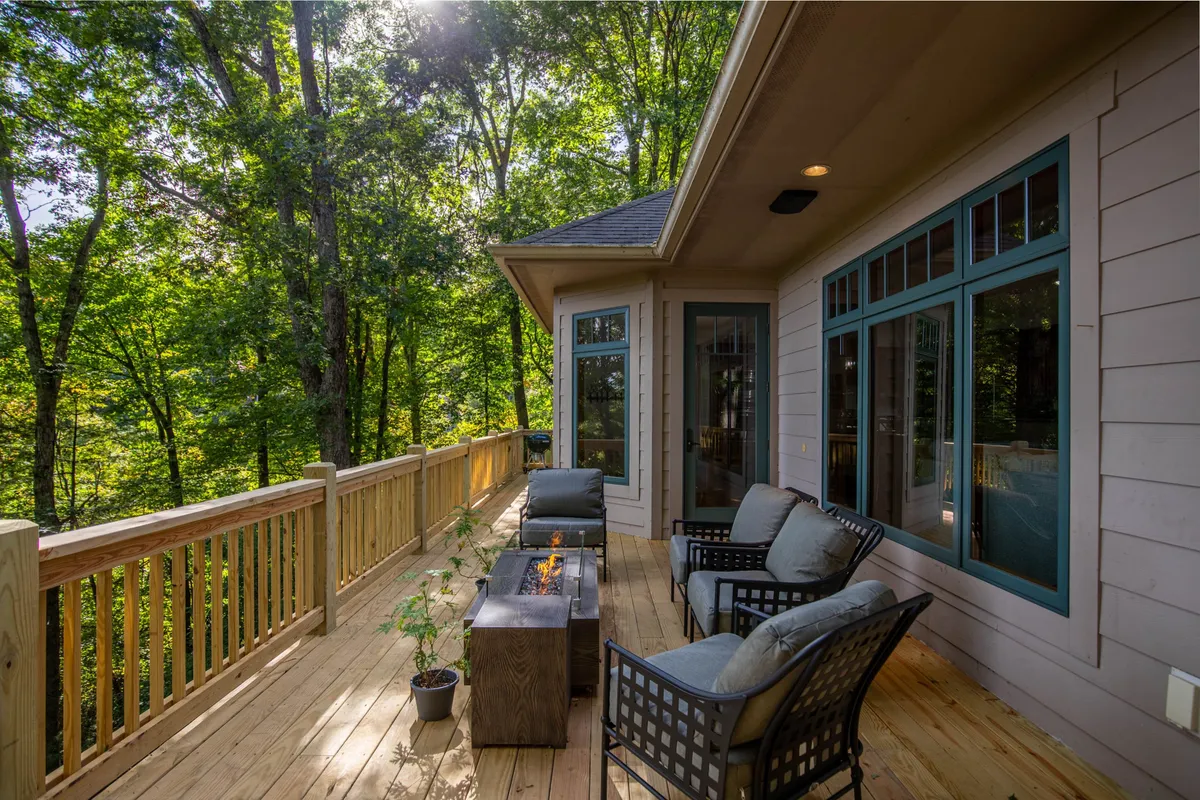 The exterior features comfortable seating arranged around a fire pit, surrounded by tranquil nature. This space is ideal for family gatherings after a day of hiking, sharing stories, or enjoying mountain evenings together.